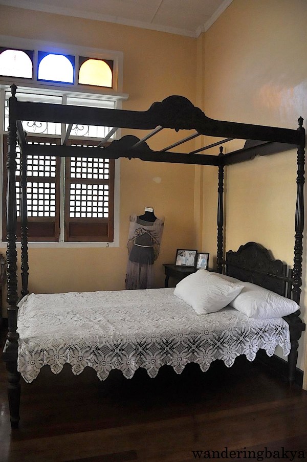 Doña Aurora’s room is dominated by a narra bed. The photos on the bedside table were taken during the inauguration of the Quezon Heritage House, a little over a year ago. 